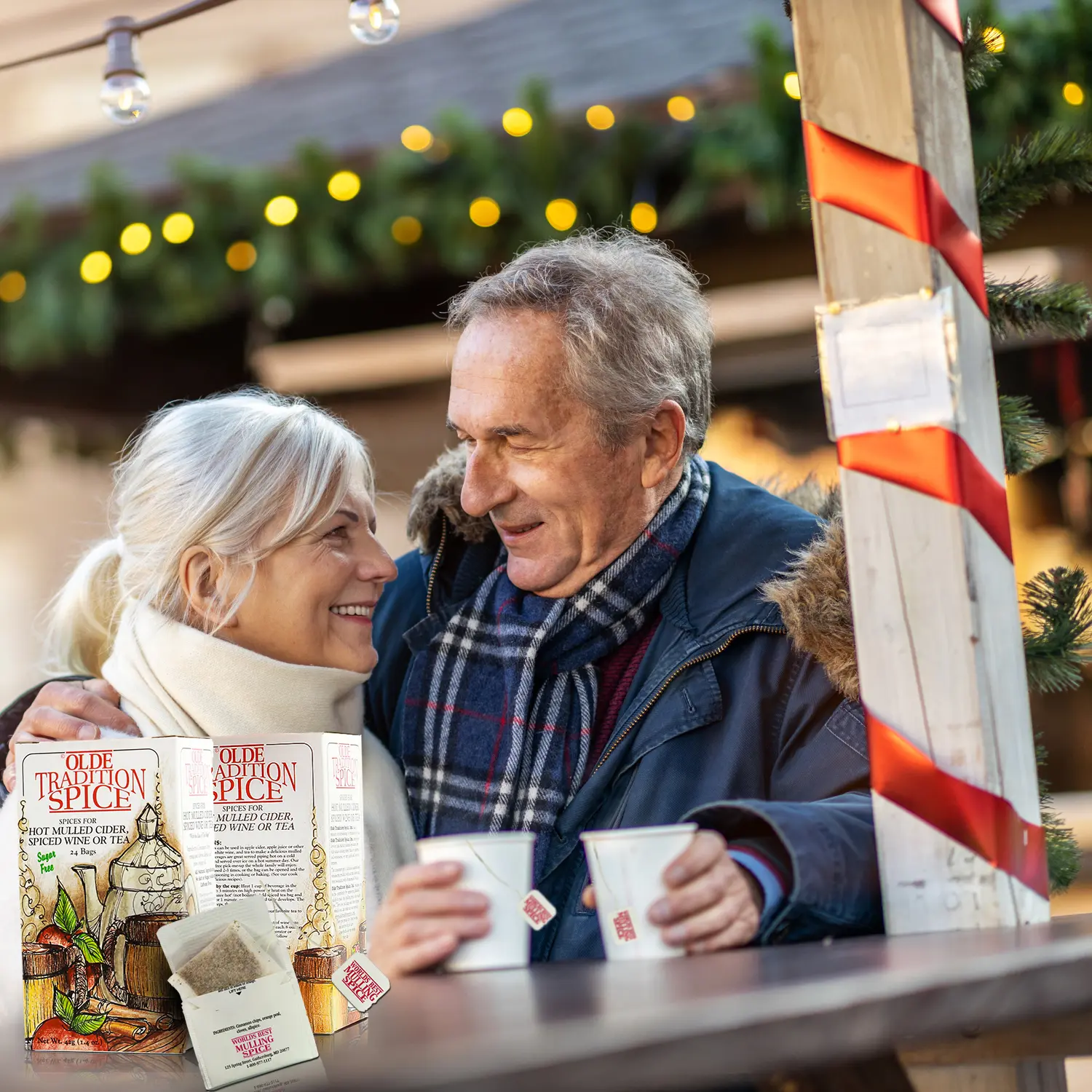 Couple enjoying warm drinks outdoors.